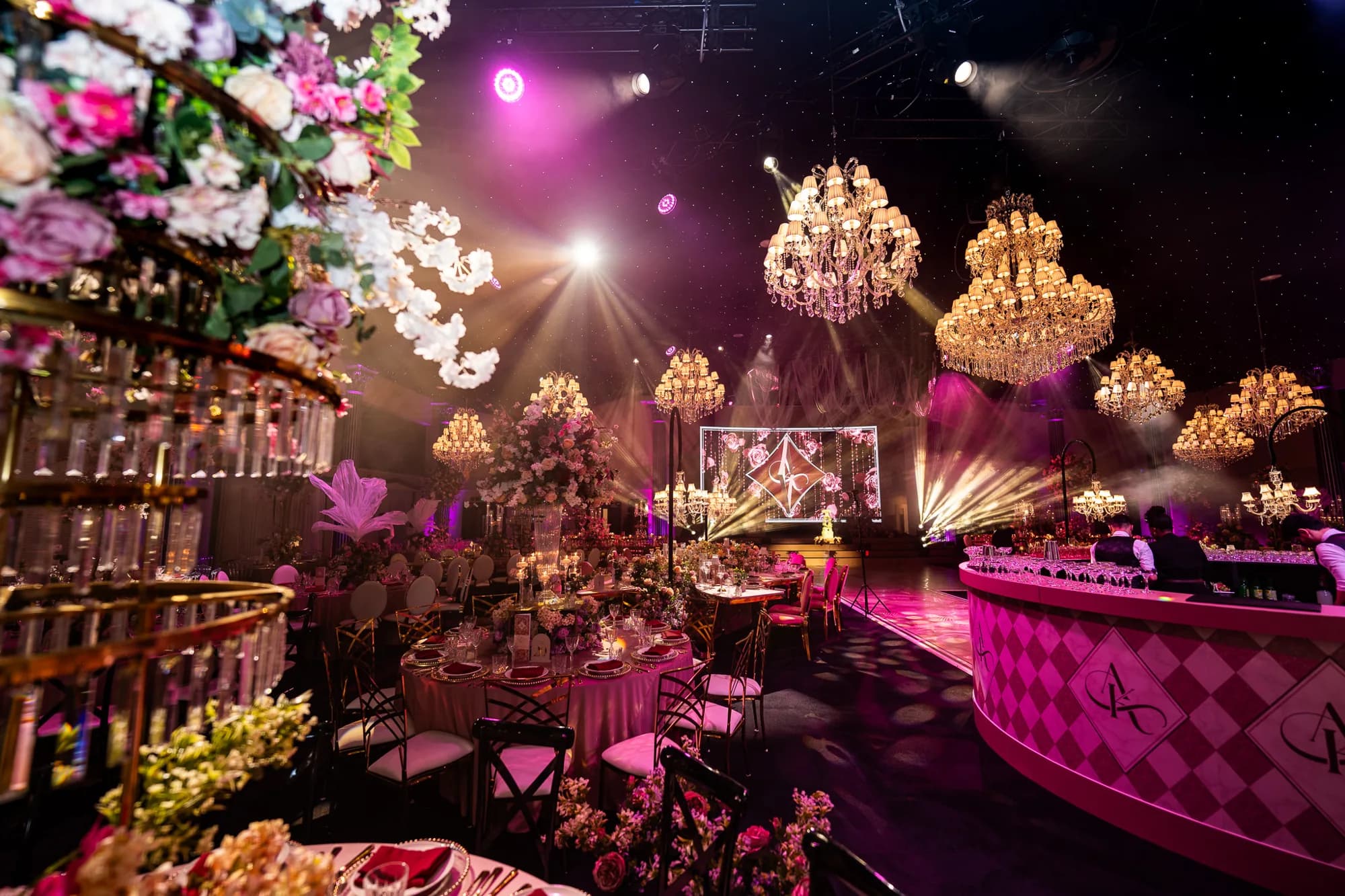 Pink reception lighting around the printed bar and banquet tables at Dallas Burston Polo Club