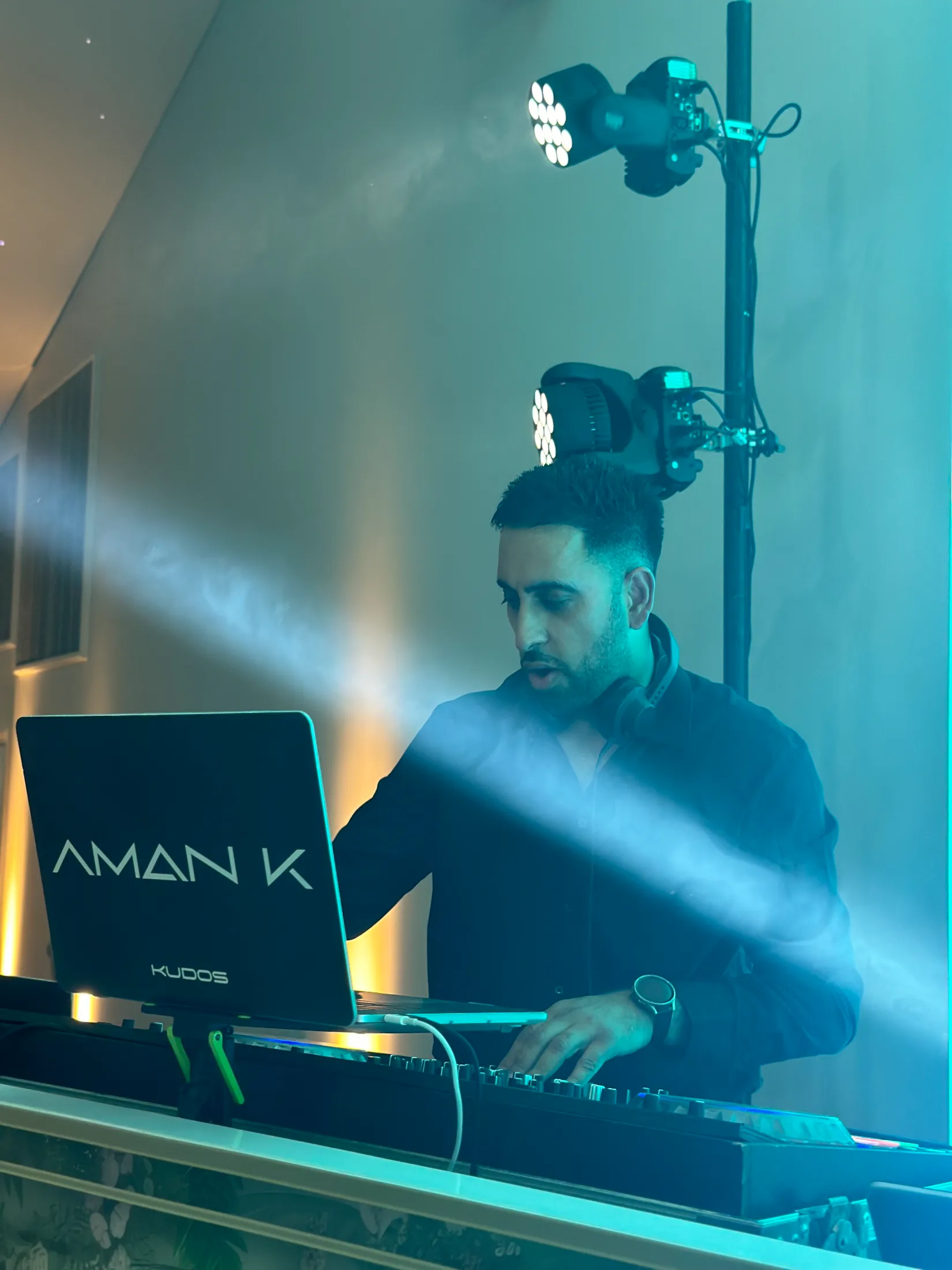 DJ Aman K mixing behind the branded Kudos booth at a wedding, Kudos Music