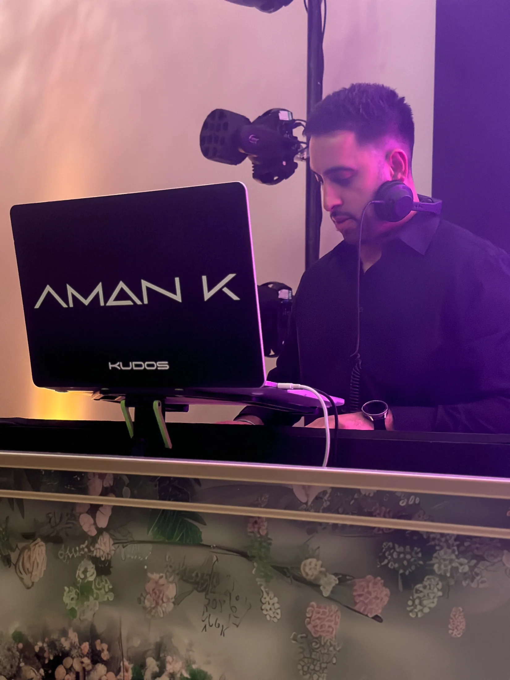 DJ Aman K mixing behind the branded Kudos booth at a wedding, Kudos Music