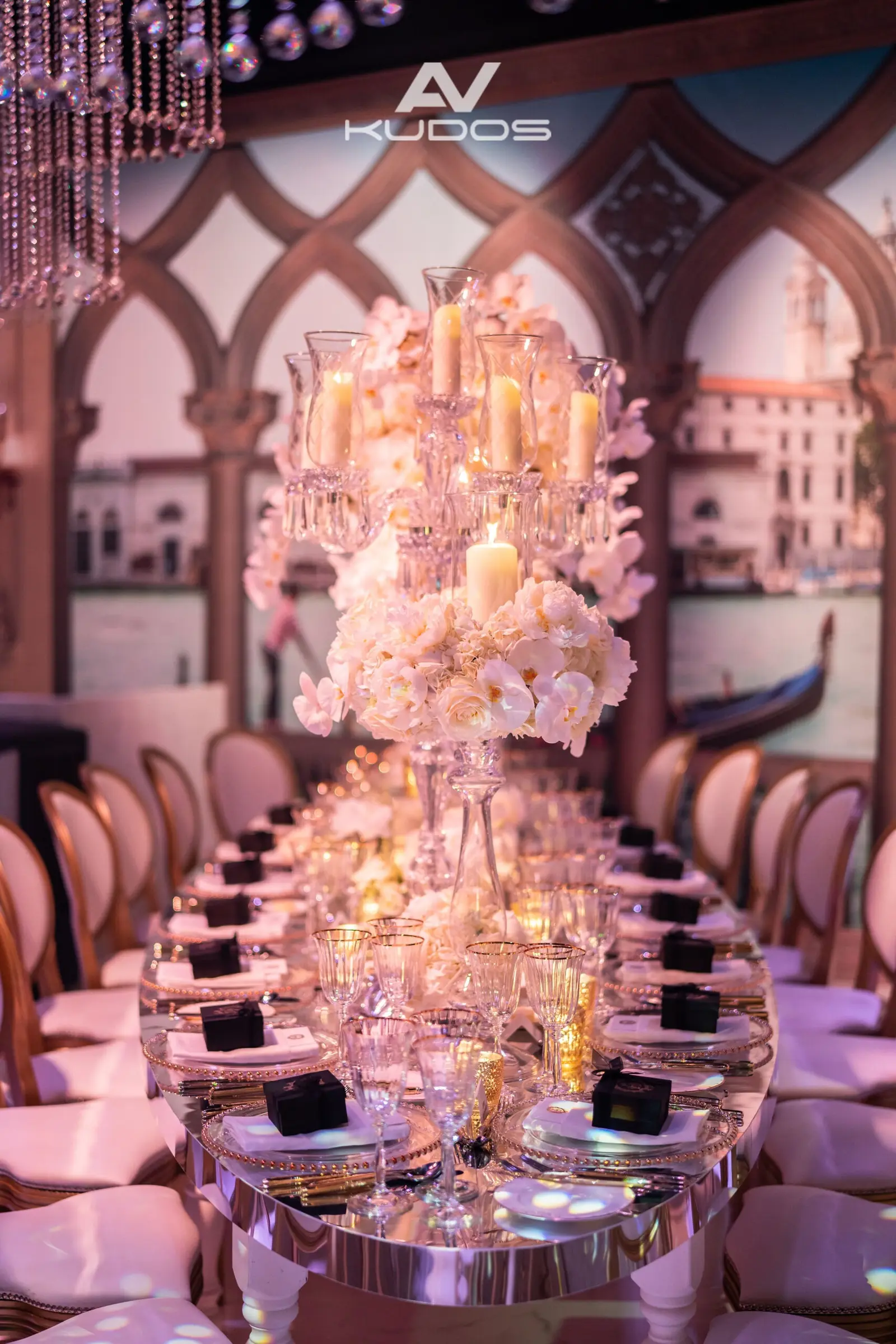 Portrait view along a floral banquet table beneath crystal strands at Claridge's