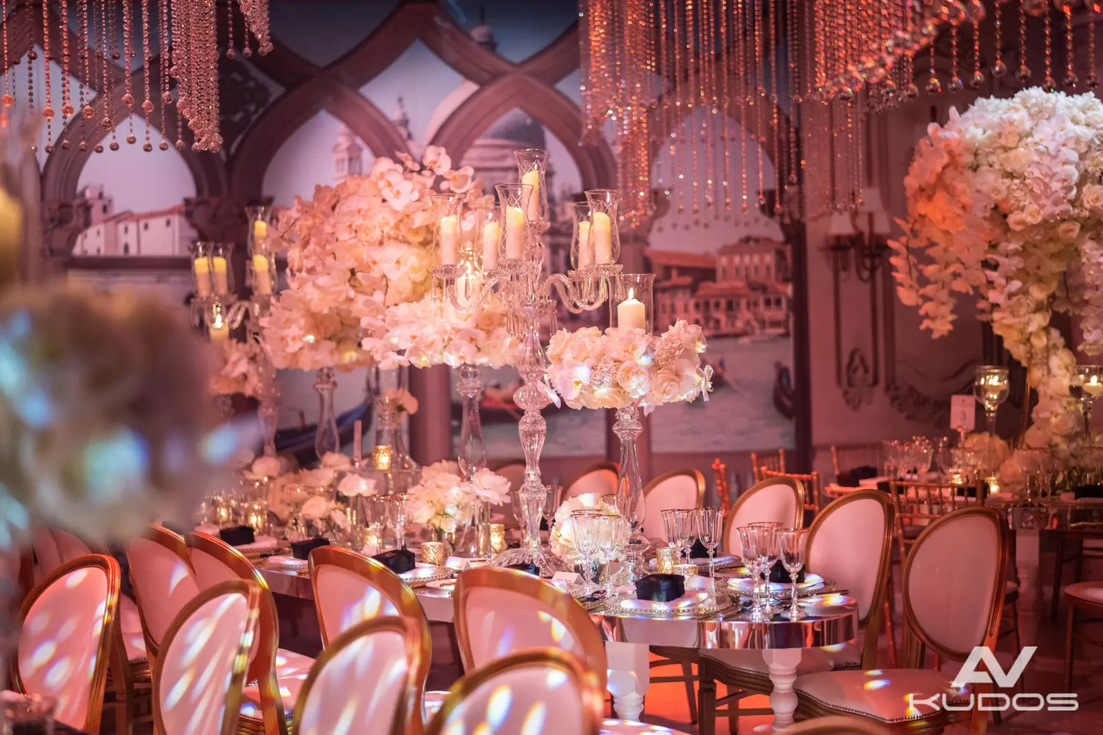 Pink-lit reception tables beneath suspended crystal decorations | Claridge's Pink-lit reception tables beneath suspended crystal decorations at Claridge's