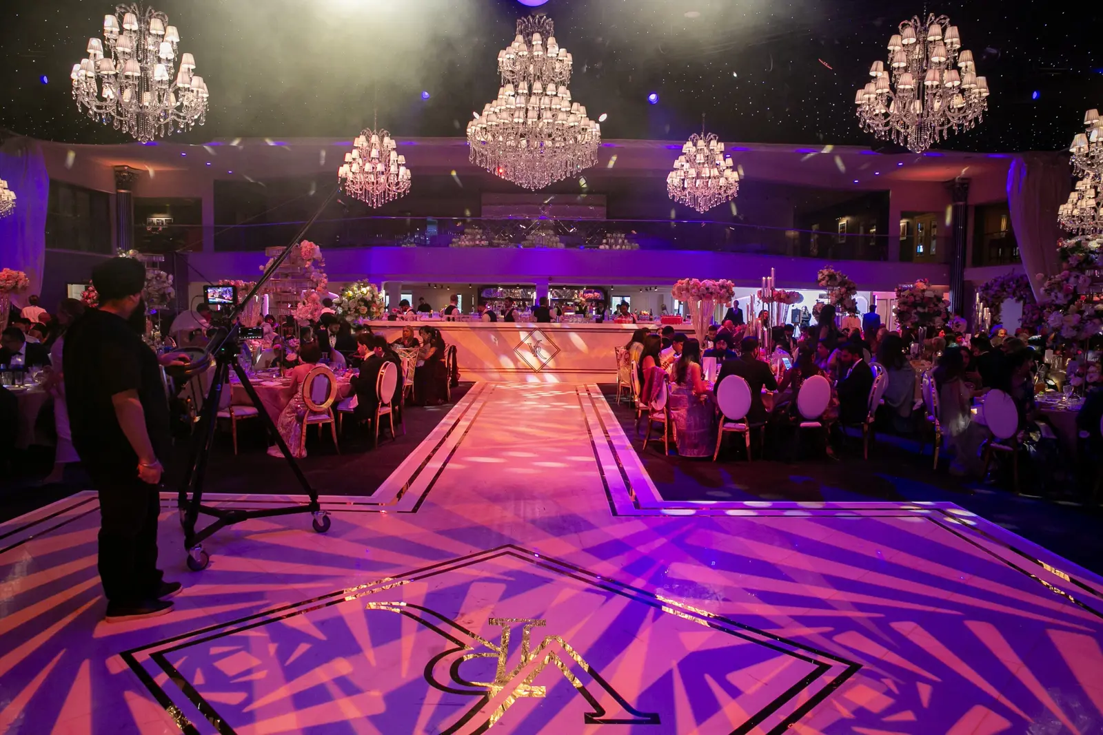 Printed wedding walkway with patterned lighting and guests on either side at Dallas Burston Polo Club
