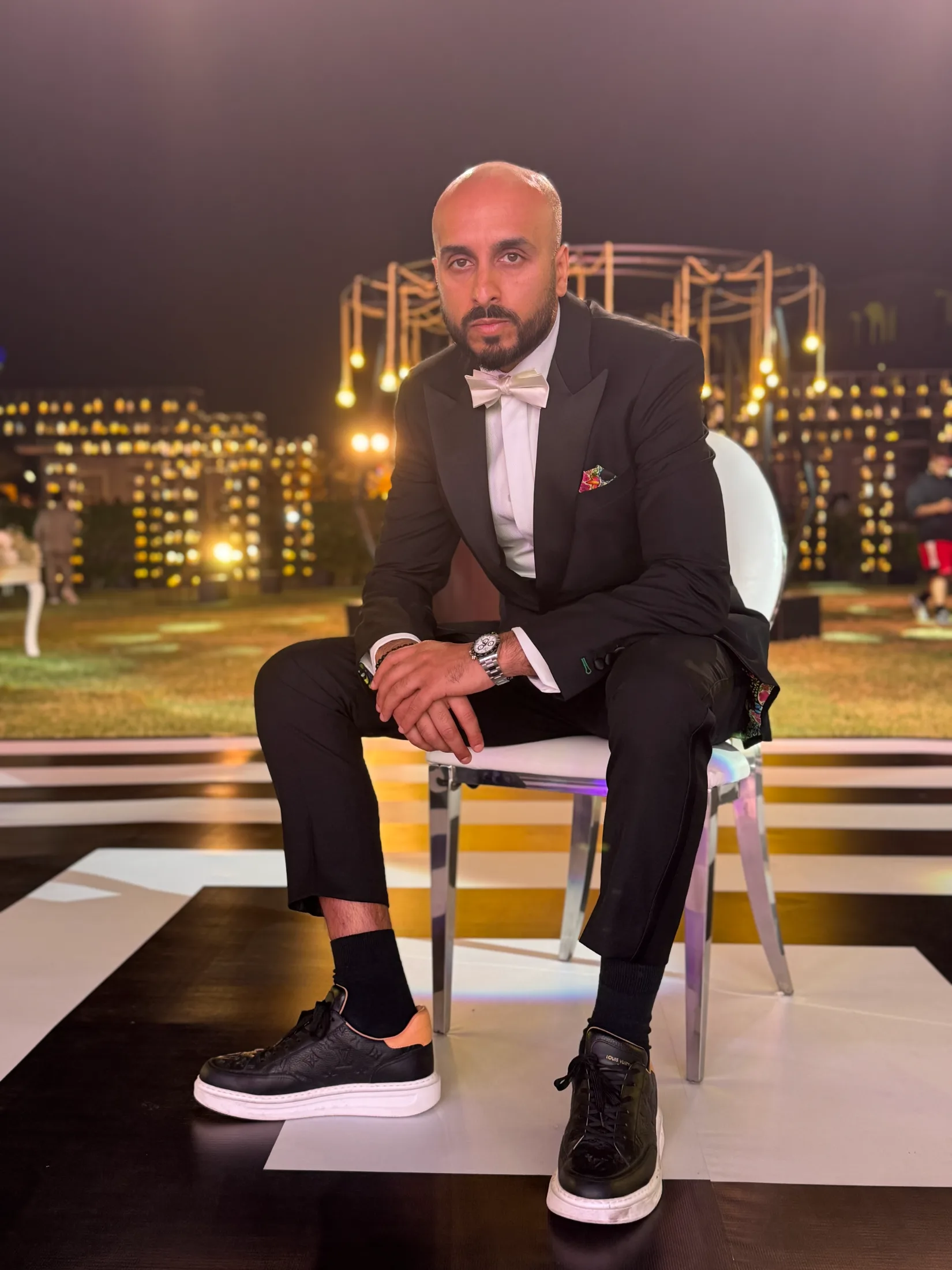 DJ H of Kudos Music in a tuxedo at an evening waterfront event