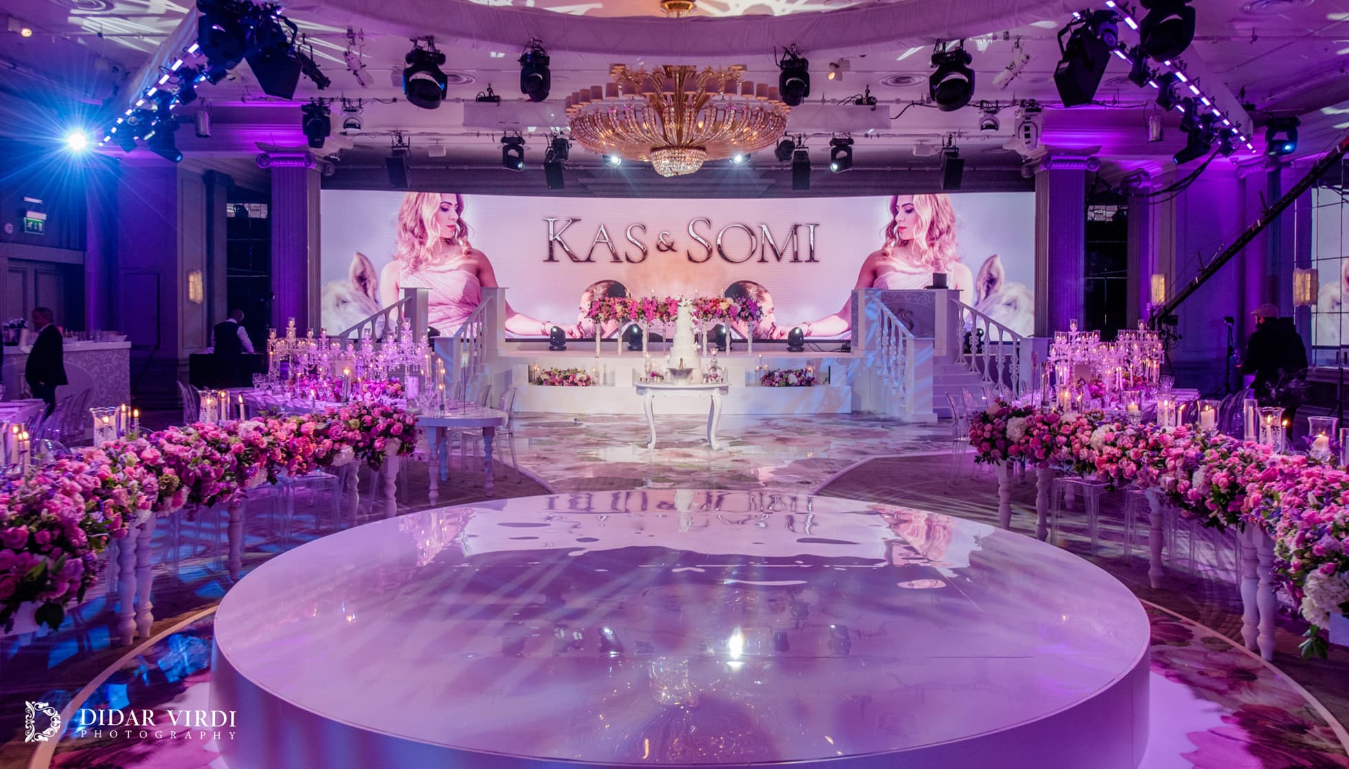 Flowers across the backdrop Floral imagery on a curved LED backdrop behind the circular first-dance stage at Grosvenor House Ballroom.