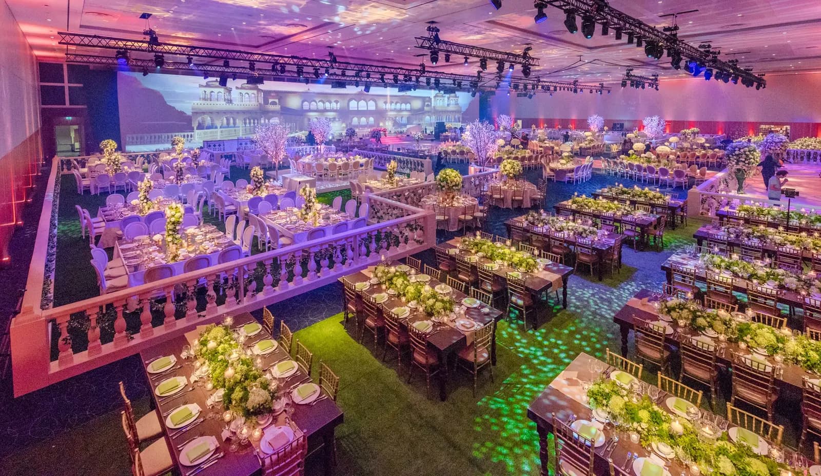 Wide ballroom view with banquet tables, overhead lighting and an illuminated walkway at InterContinental O2