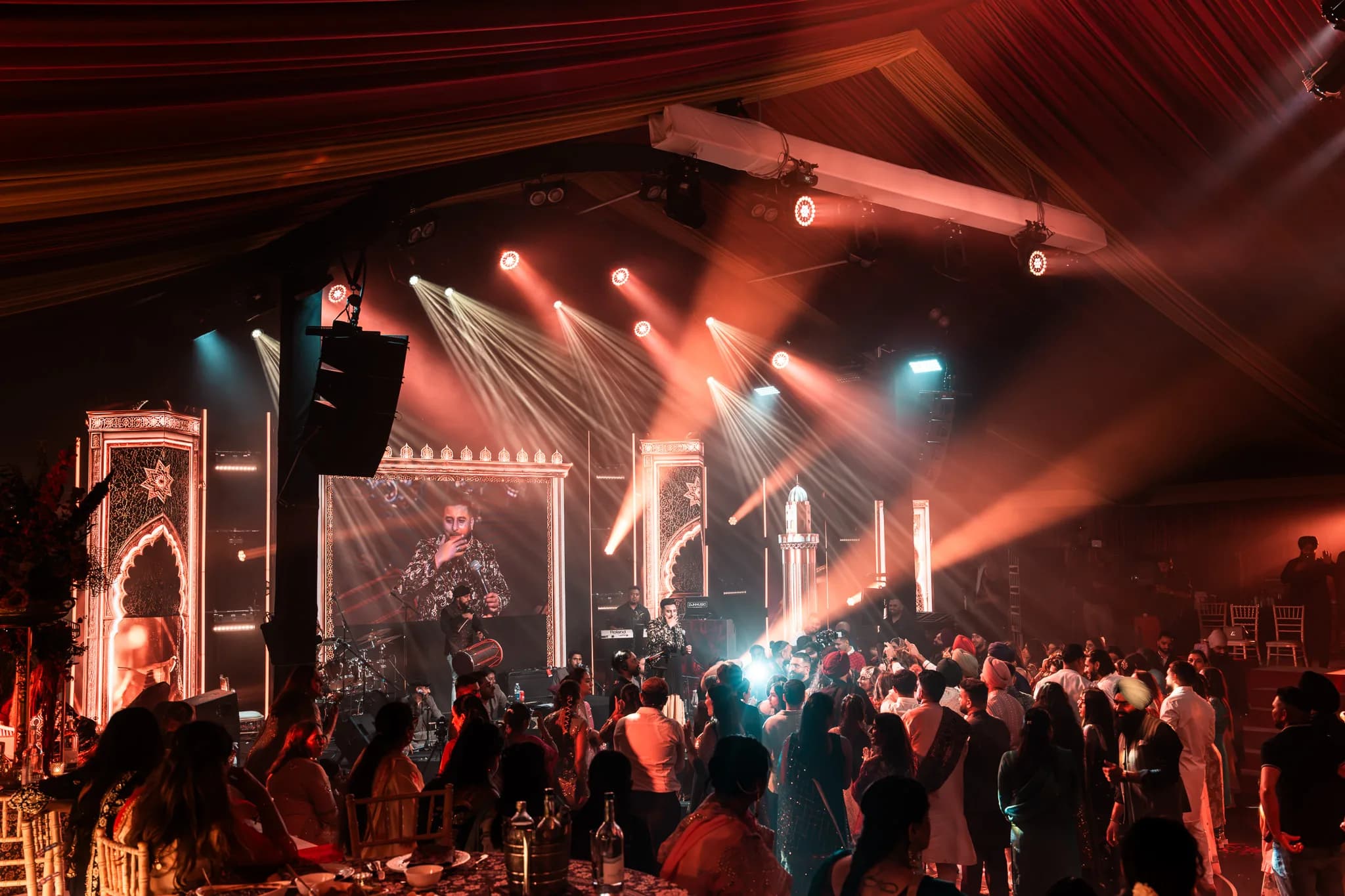 The party at its height at Eksimran and Dilraj's sangeet, the singer on screen and beams raking the room, Kudos Music