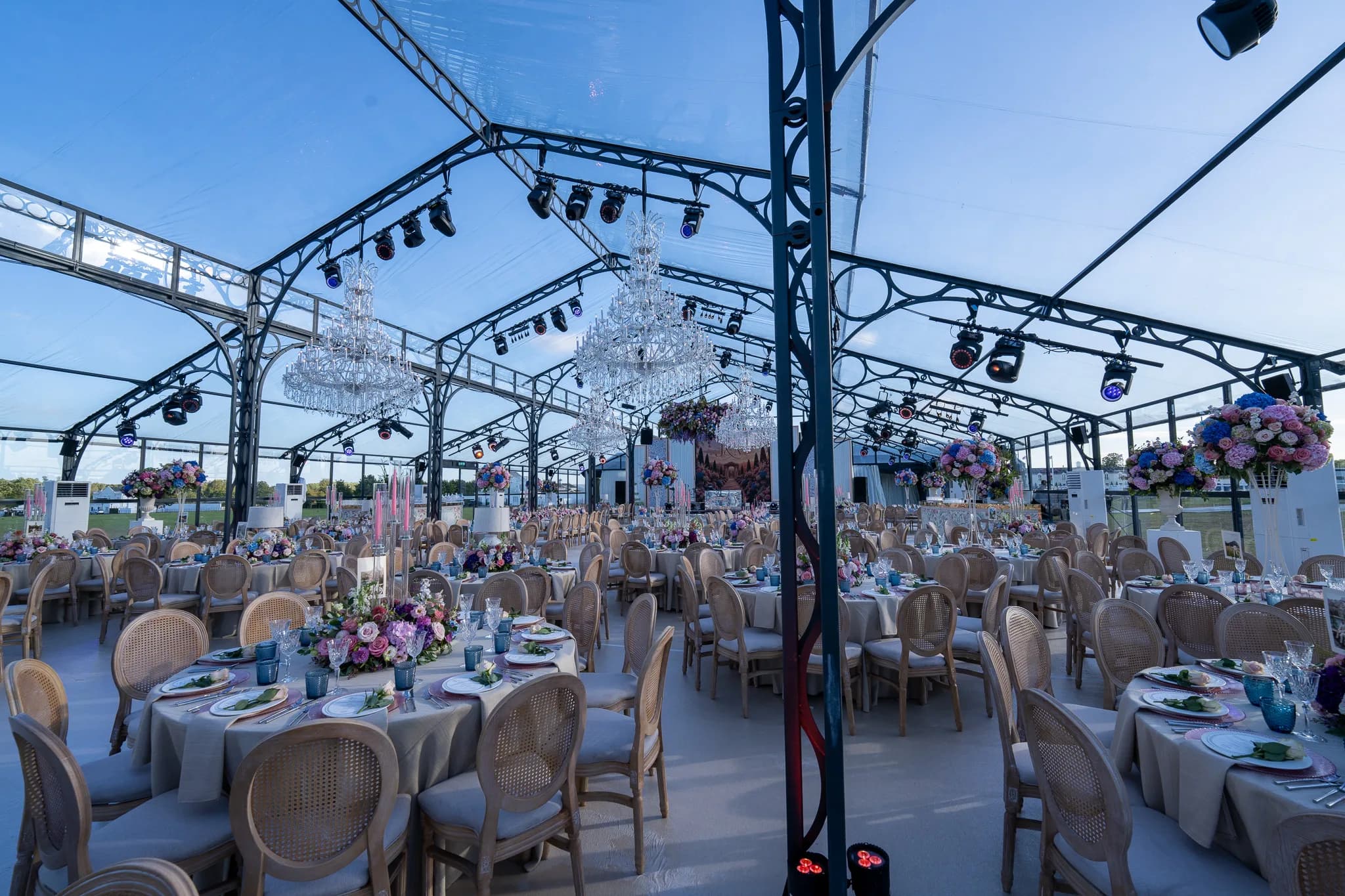 Reception tables beneath the glass roof and installed lighting rig | Dallas Burston Polo Club Reception tables beneath the glass roof and installed lighting rig at Dallas Burston Polo Club