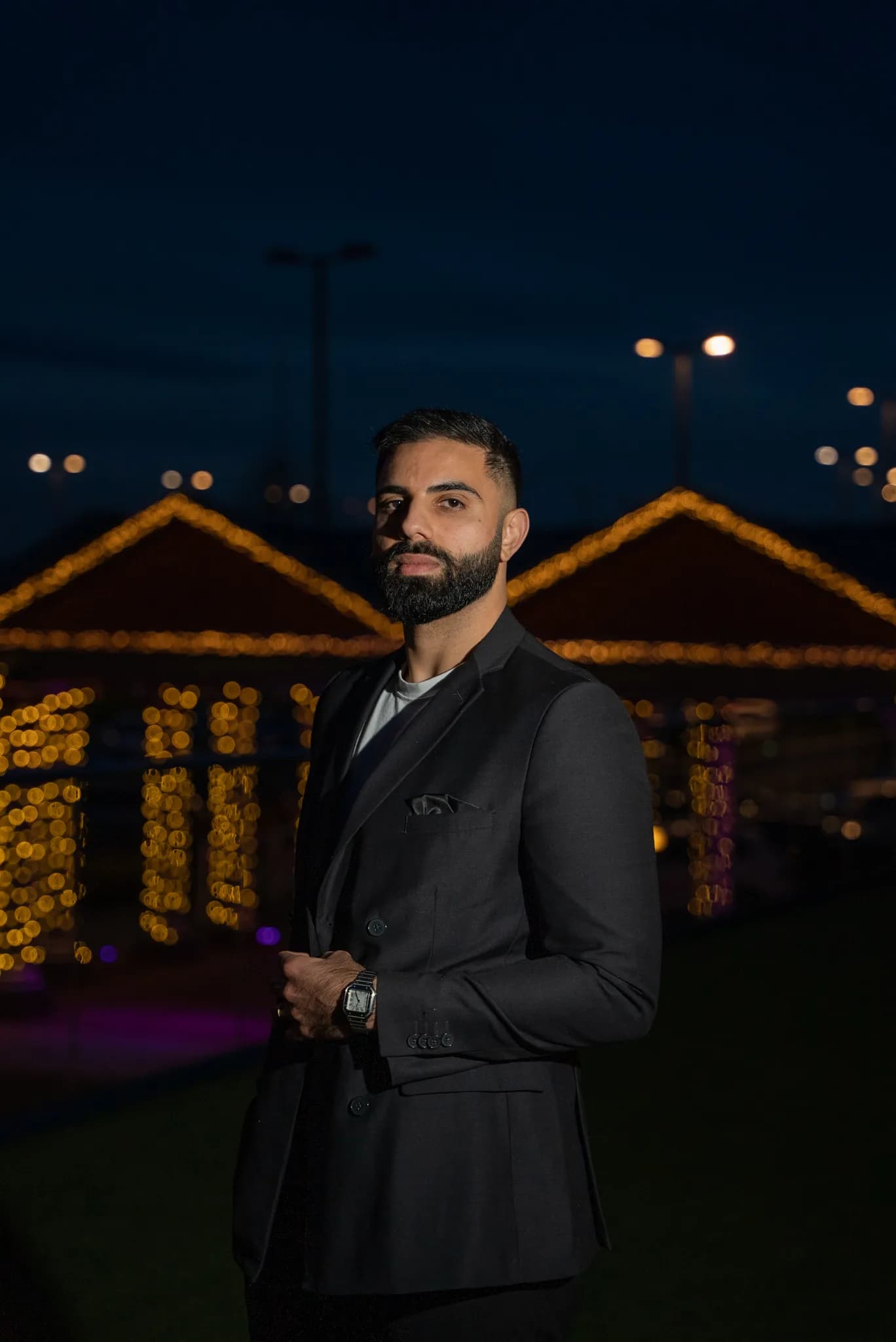 DJ Kabir in a suit at a rooftop event at dusk, Kudos Music