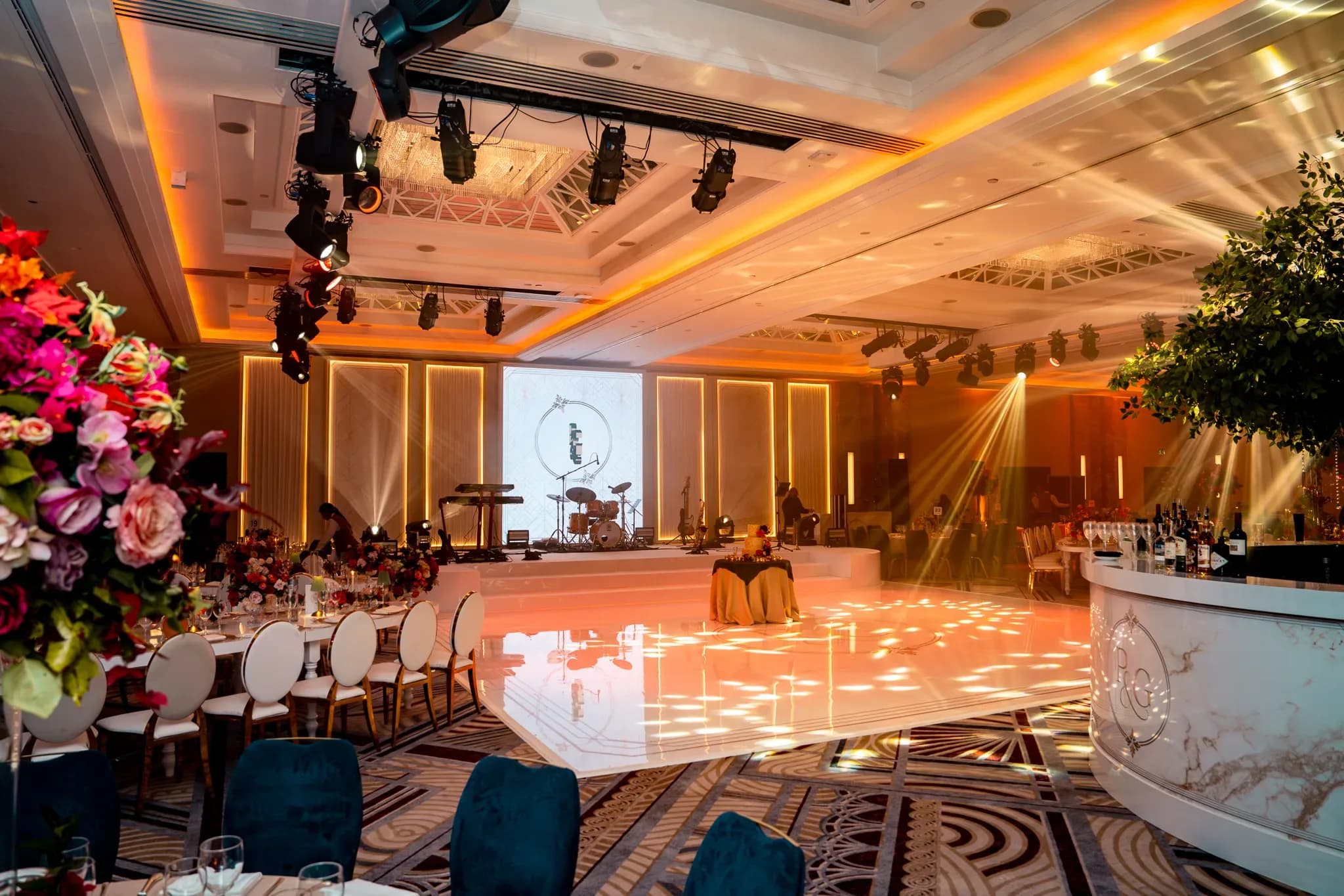A ballroom made personal | Royal Lancaster London | Kudos Music The monogrammed bar, dining tables and white dancefloor at Pooja and Gary’s Royal Lancaster London reception.