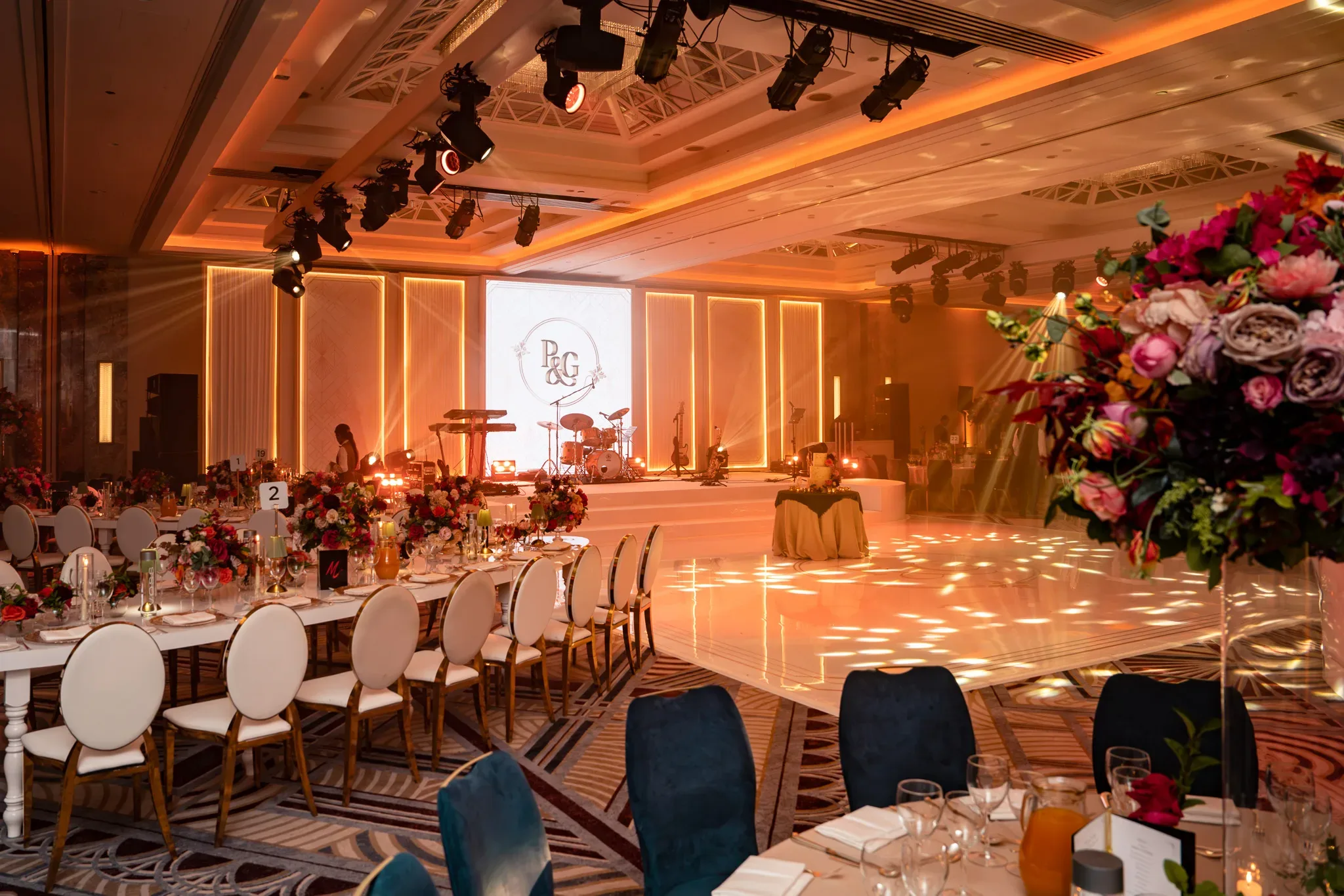 A view of the dancefloor | Royal Lancaster London | Kudos Music The white wedding dancefloor and illuminated stage seen from the guest tables at Royal Lancaster London.