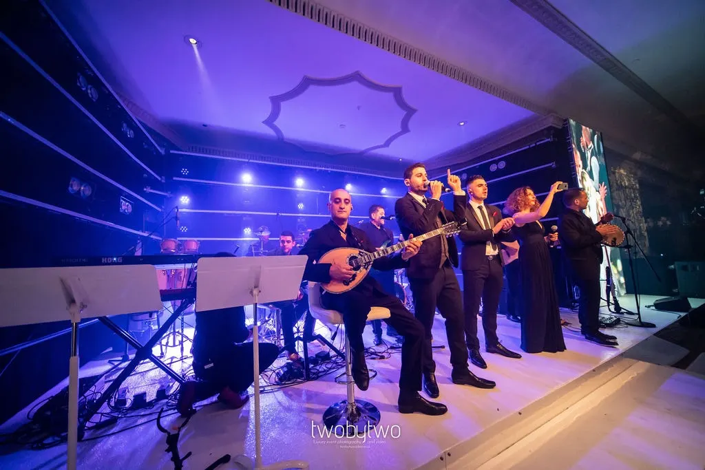 Live wedding band performing under blue stage lighting at The Dorchester