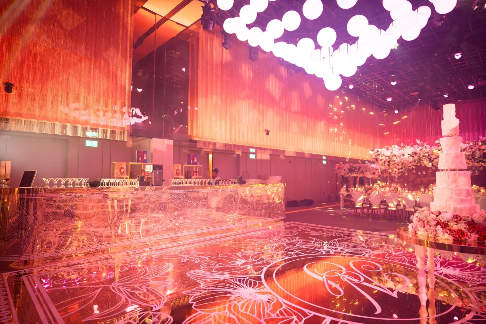 Gold-patterned mirror dancefloor and bar beneath warm pink lighting at The Londoner