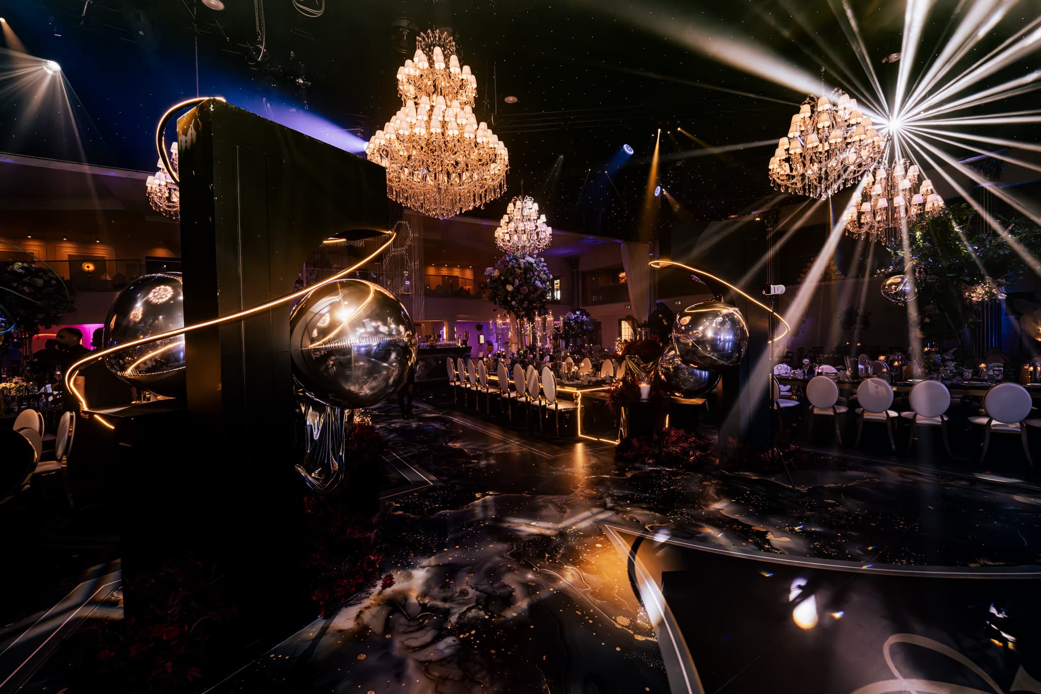 Golden spheres and beam lighting over the guests as the party built at Charan and Puneet's Dallas Burston wedding, Kudos Music