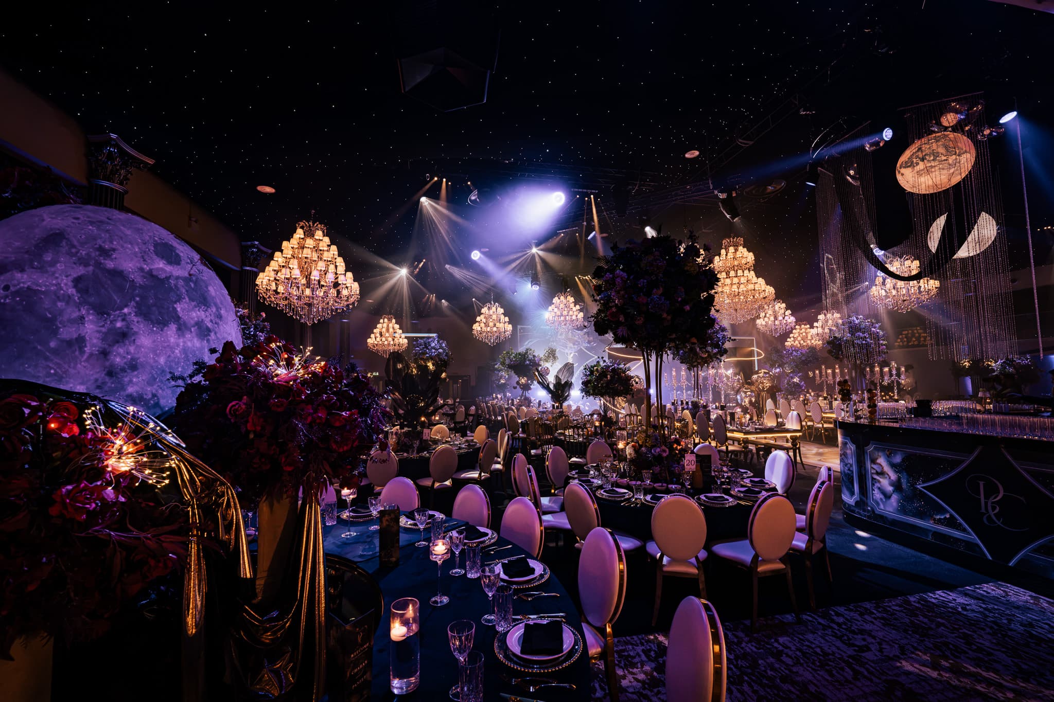 A wedding night at Dallas Burston Polo Club in violet light, the moon on the screen behind the DJ stage, Kudos Music