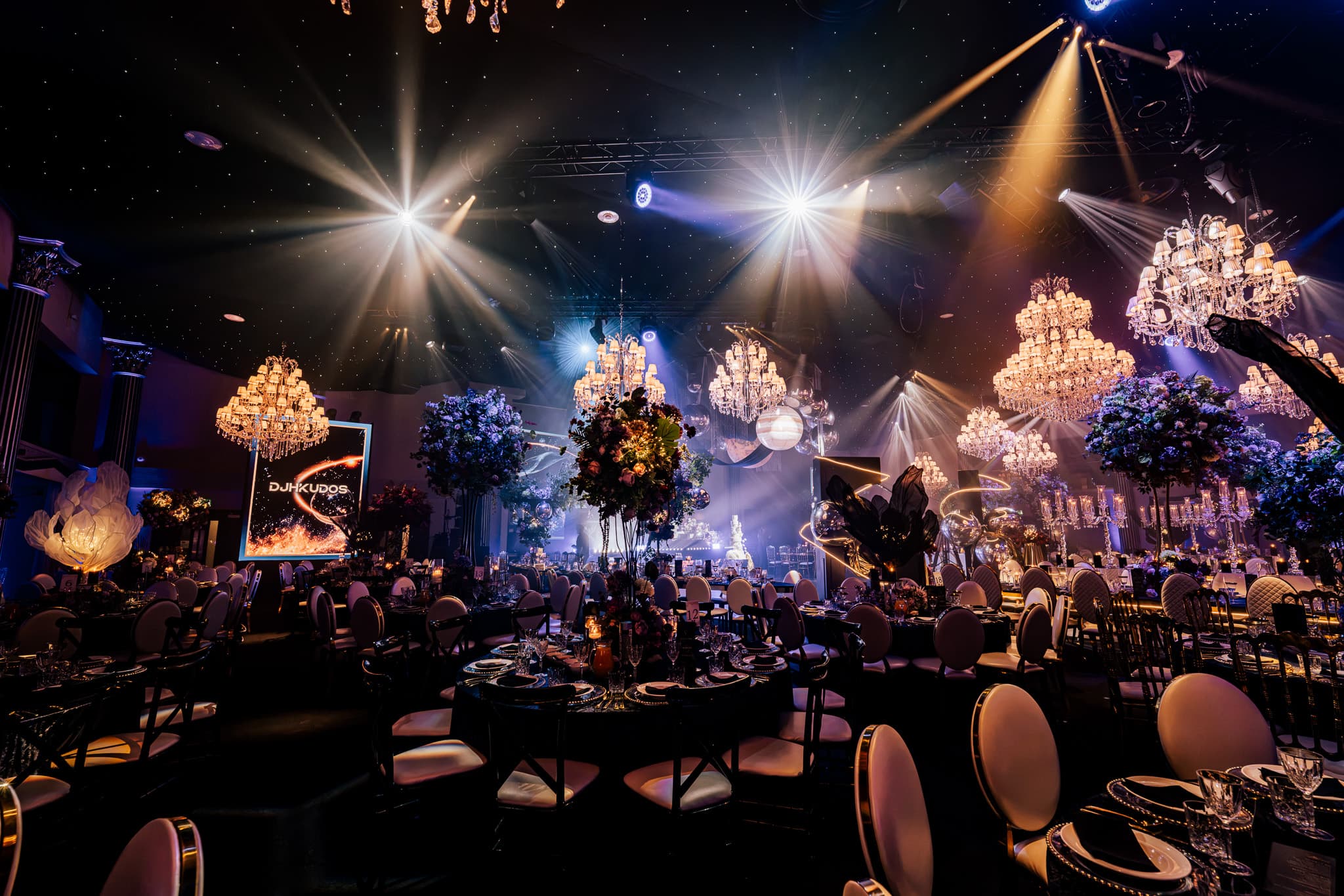 Floral centrepieces on the round tables, the party still an hour away, at Charan and Puneet's Dallas Burston wedding, Kudos Music