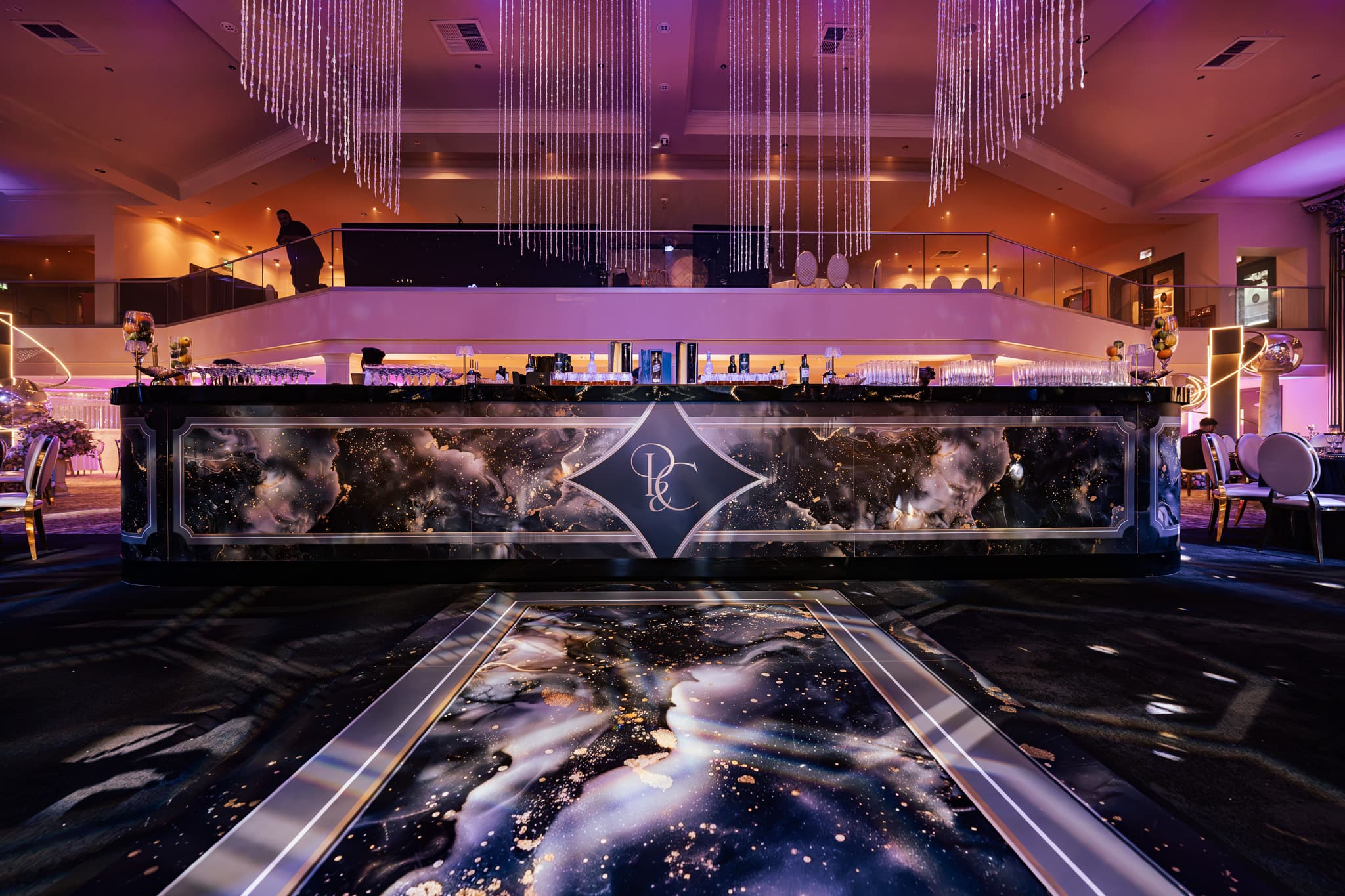 The Syrup Bar counter with cosmic backlit panels in purple light at Charan and Puneet's Dallas Burston Polo Club wedding, Kudos Music